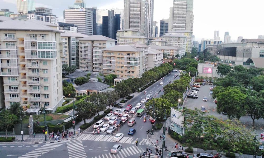 Busy city intersection with heavy traffic and surrounding buildings showing how property surveys guide rezoning and development
