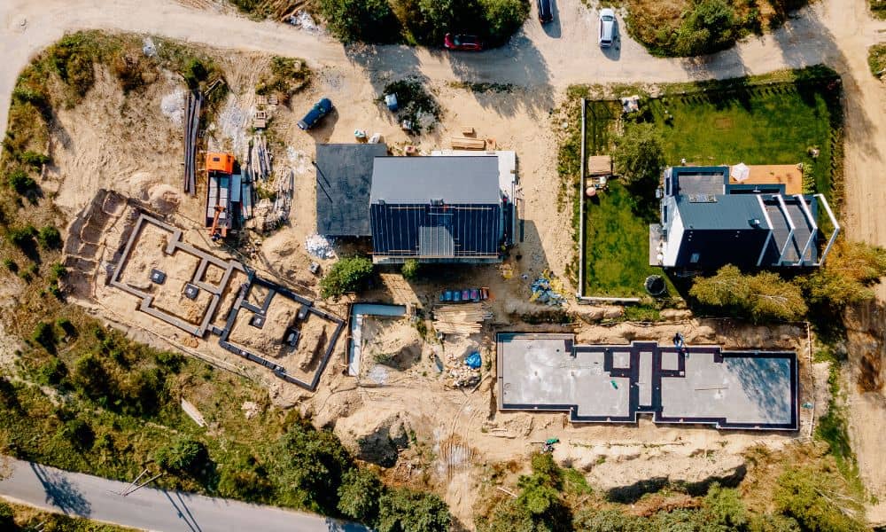 Aerial view of an active construction site with foundations being prepared, showing how detailed construction plans guide each stage of the work