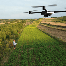 A drone surveying a field, capturing aerial data for mapping and planning construction projects
