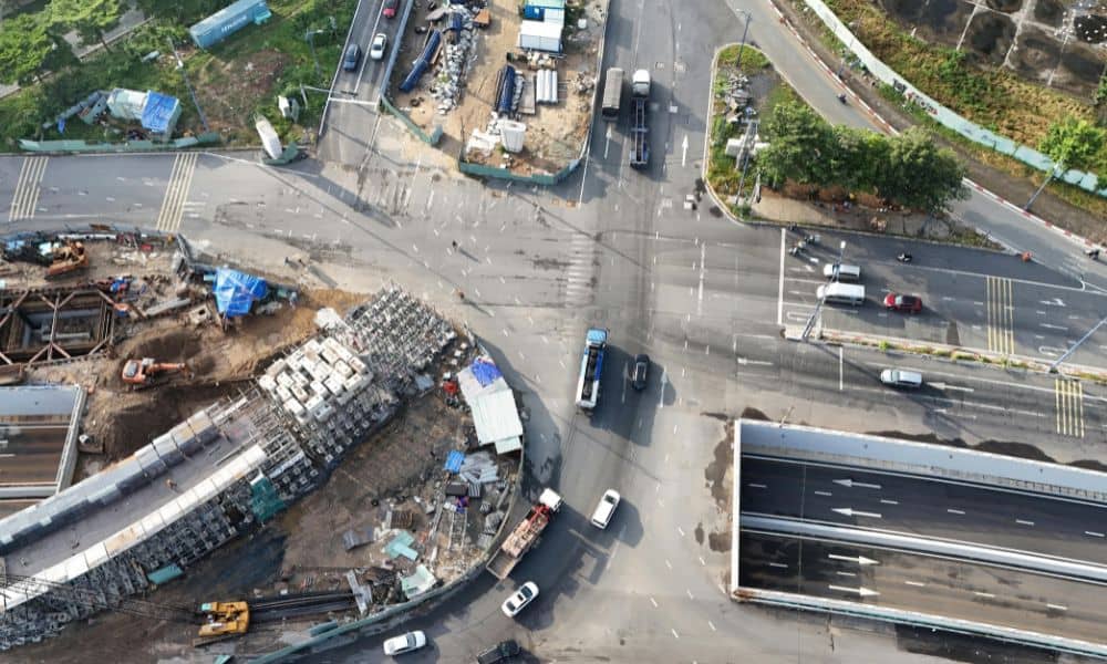 Aerial view of an urban roadway design project showing traffic shifts, construction phasing, and active work zones at a major intersection