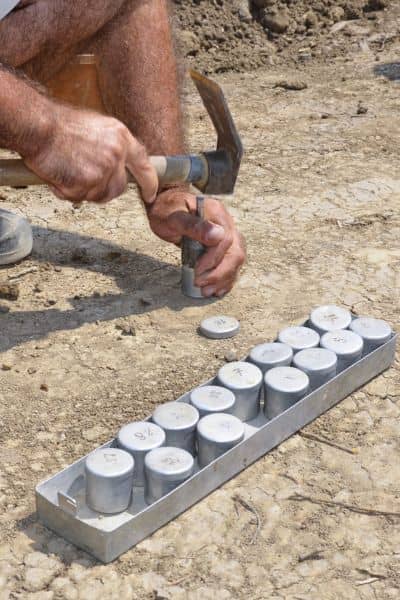 Engineer performing soil testing for a retaining wall at a land development site