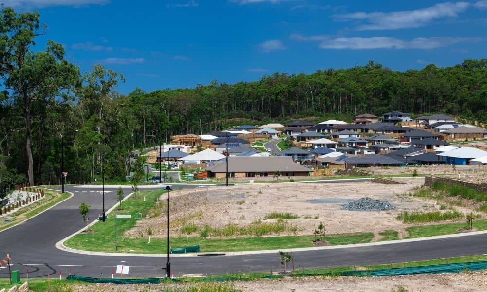 Aerial view of suburban development with new homes and open land, showing how survey mapping supports planning and growth