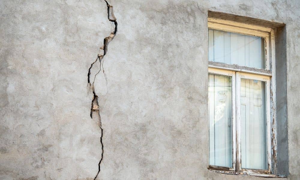 Wall inside a home with a visible crack near the window, showing a potential structural issue for a structural engineer to assess
