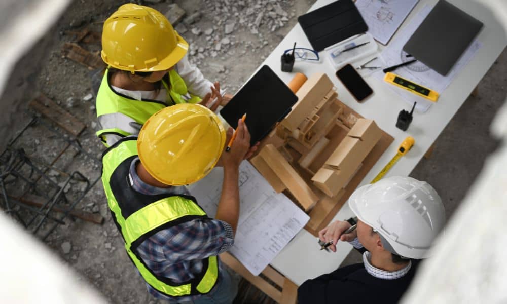 Engineers reviewing construction plans and discussing design details during an engineering design review