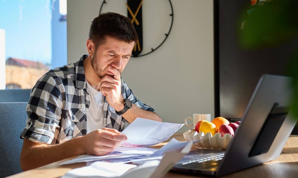 Person reviewing property documents at home before reaching out to a surveyor
